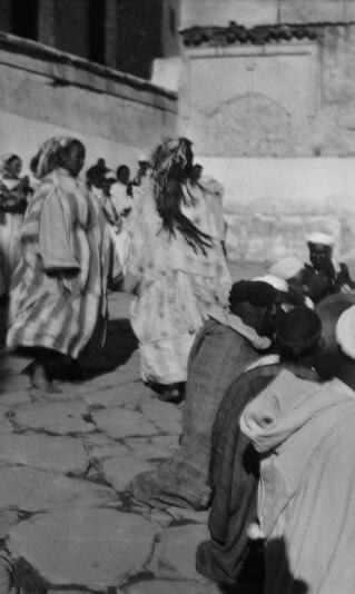 Berber dancers in action within a courtyard setting. Image not quite in focus. Telouet, 13th January 1936.