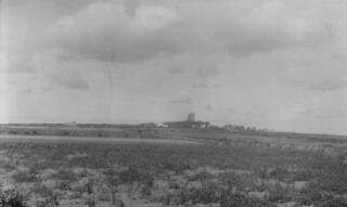 Flat landscape with castle in distance. Location unknown. Image not in focus.