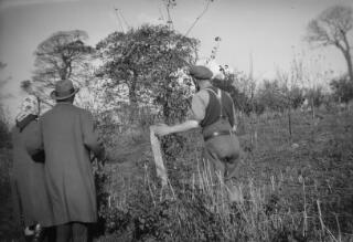 David & Countess Lloyd George talking to a farmhand, probably at Ty Newydd. All have their backs to the camera.