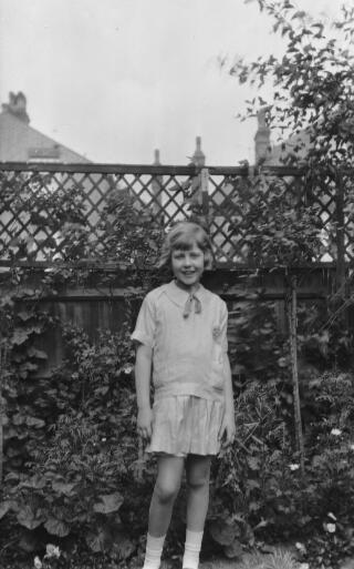 Maureen Sylvester aged about ten photographed in a garden.