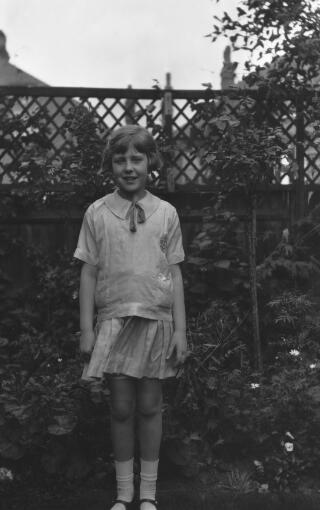 Maureen Sylvester aged about ten years old photographed in a garden.