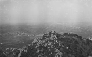 Panorama from a high vantage point looking down onto hilltop fortifications (the Moorish Castle) and a scattered settlement in the valley below.