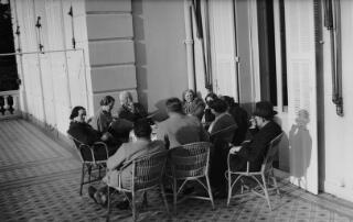The Lloyd George entourage on a hotel balcony seated around a table. Those identifiable are David, Margaret, Gwilyn and Megan Lloyd George. The other six individuals have not been identified.