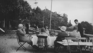 David Lloyd George and party being served by a waiter, location unknown.
