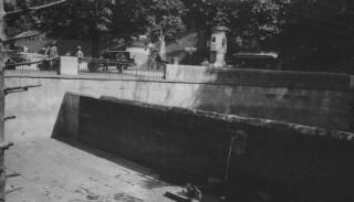 View of the Bear pit, a bear in the water in the foreground.
