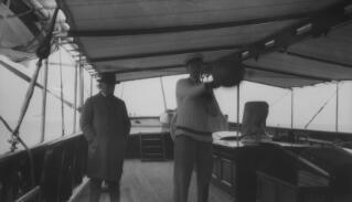 David & Gwilym Lloyd George on the deck of 'Sabrina.' Gwilym is amusing himself with a punchbag.