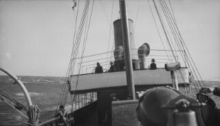 The Bridge of the 'Sabrina' as seen from the deck. Various members of the Lloyd George party and crew are milling around.