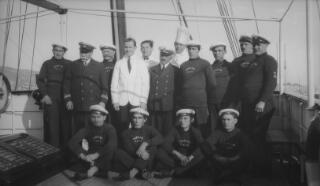 Formal portrait of the captain and crew of the yacht 'Sabrina' on the deck of the vessel.