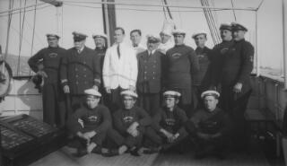 Group photograph of the captain and crew of the yacht 'Sabrina' on deck.