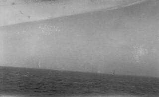 A lighthouse surrounded by sea as seen from a distance. Possibly taken from the deck of 'Sabrina.'