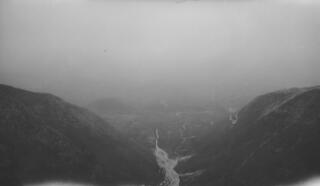 Looking down into a cultivated valley far below, location unknown