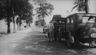 The three cars in the entourage parked at the side of the road, Inspector Pavey is milling around.