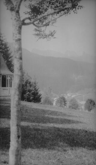 View, possibly from hotel grounds to distant mountains. There is a gazebo in the left foreground. Location unknown.