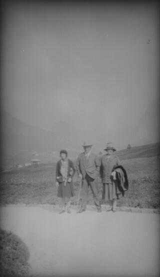 Megan, David & Margaret Lloyd George standing at the side of a road, a village visible in the valley below. From their dress this would appear to have been taken on the day they visited the Italian battlefields.