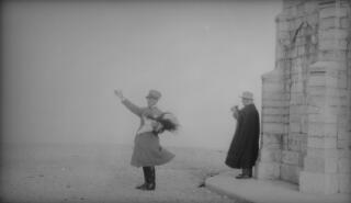 D Lloyd George stands with his back to the mausoleum whilst his guide is pointing at something out of left hand side of the picture.