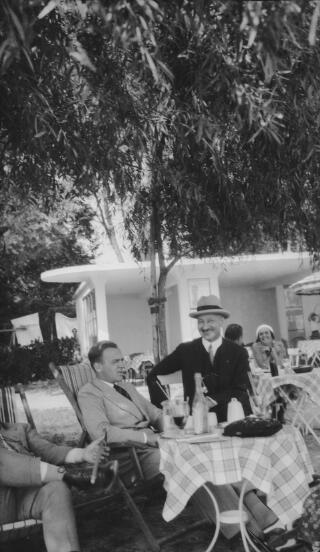 Gwilym Lloyd George and an unidentified man sitting at a cafe table.