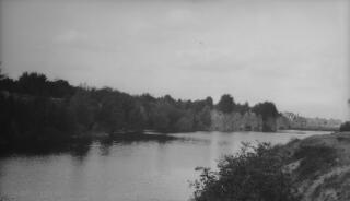 Unidentified river, a settlement visible in the distance.
