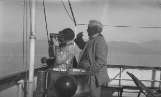 The three Lloyd George's looking at something in the distance from the deck of 'Sabrina', Megan using binoculars.