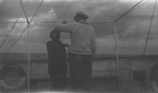 Gwilym Lloyd George in white cricketing sweater and the captain of "Sabrina" in animated conversation.