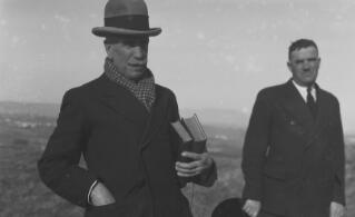 Two men, one in a uniform the other smartly dressed wearing a grey Homburg and with two books under his arm. The smarter of the two appears in other photos and may have been a guide for parts of their trip.