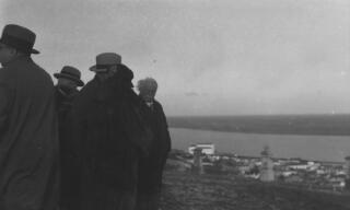 The Lloyd George entourage standing at a vantage point overlooking a river, location not known.